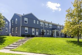 Omaha townhouse for rent - A blue building with a white door and windows.