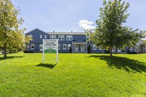 Omaha townhouse for rent - A blue building with a sign in front of it.