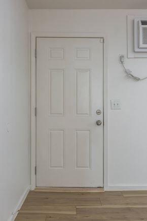 Omaha apartment for rent - A white door with a silver handle and a window above it.