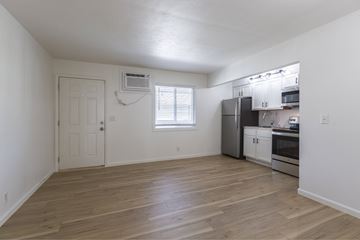 Omaha apartment for rent - A kitchen with white cabinets and a wooden floor.