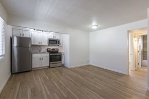 Omaha apartment for rent - A kitchen with a refrigerator, oven, microwave, and cabinets.