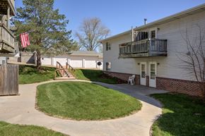 Gretna apartment for rent - A small American flag hangs from a tree in a grassy area.