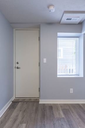 Omaha apartment for rent - A white door is in a room with a window.