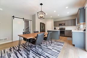 Omaha townhouse for rent - A modern kitchen with a dining table and chairs.