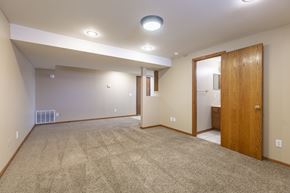 Omaha apartment for rent - A spacious room with a carpeted floor and a ceiling light.