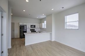 Council Bluffs apartment for rent - A kitchen with a white countertop and wooden flooring.