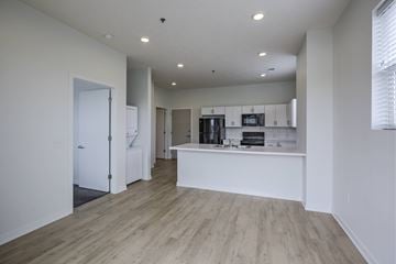 Council Bluffs apartment for rent - A kitchen with white cabinets and a wooden floor.