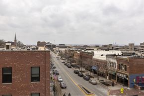 Council Bluffs apartment for rent - A city street with cars and buildings.