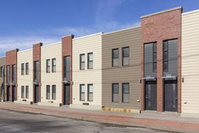 Council Bluffs apartment for rent - A row of modern buildings with a red brick building on the end.