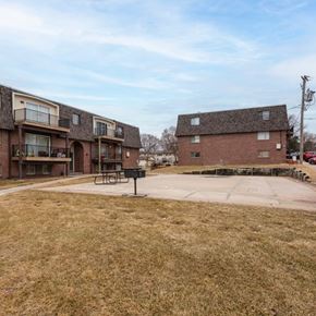 Omaha apartment for rent - A grassy area in front of apartment buildings with a picnic table.