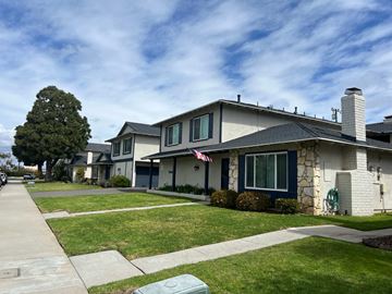 Huntington Beach apartment for rent - A house with a grey roof and a flag on it.