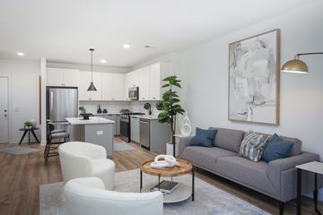 Carteret apartment for rent - A modern living room with a grey couch and a wooden coffee table.