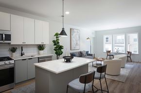 Carteret apartment for rent - A modern kitchen with a large island and a dining area with chairs.