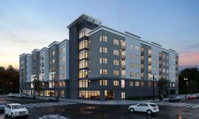 Carteret apartment for rent - A large, modern apartment building with cars parked in front.