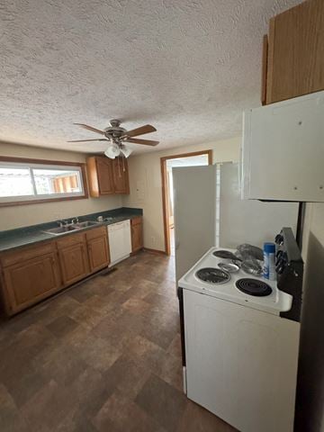 Bristol apartment for rent - A kitchen with a white refrigerator and a white stove top oven.