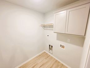 Copperas Cove house for rent - A white cabinet with a shelf and a small hole in the wall.