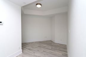 Toronto apartment for rent - A room with a wooden floor and white walls.