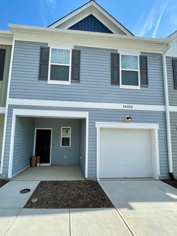 Wilson apartment for rent - A two-story house with a garage and a white door.
