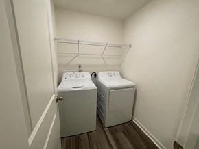 Wilson apartment for rent - A laundry room with two washing machines and a clothes dryer.