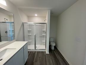 Wilson apartment for rent - A bathroom with a walk-in shower and a toilet.