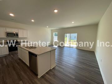Wilson apartment for rent - A kitchen with white cabinets and a countertop is shown.