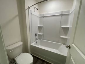 Wilson apartment for rent - A white toilet and sink in a small bathroom.