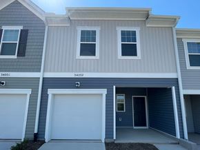 Wilson apartment for rent - A two-story house with garage doors and windows.