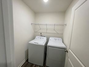 Wilson apartment for rent - A small laundry room with a washer and dryer.
