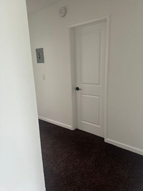 Westminster apartment for rent - A white door is in a white room with a carpet.