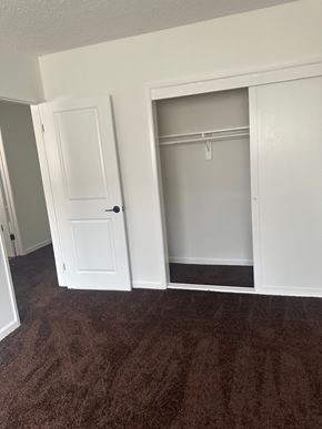 Westminster apartment for rent - A white door is open to a small closet.