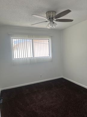 Westminster apartment for rent - A room with a ceiling fan and a window with blinds.