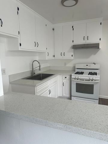 Westminster apartment for rent - A white kitchen with a sink and stove.