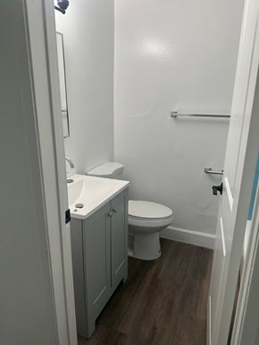 Westminster apartment for rent - A white toilet and sink in a small bathroom.