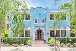 Tampa apartment for rent - A blue building with a black gate in front.