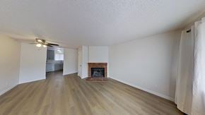 Edgewater house for rent - A living room with a fireplace and wood flooring.