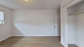 Edgewater house for rent - A room with a white door and a window with blinds.