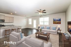 Newnan house for rent - A spacious living room with a kitchen area in the background.