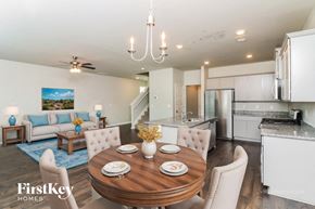 Newnan house for rent - A modern dining room with a wooden table set for two.