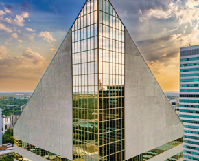 Edmonton apartment for rent - A modern building with a triangular glass facade is reflected in its own windows.