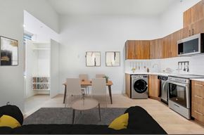 Edmonton apartment for rent - A modern kitchen with a dining table and chairs.