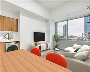 Edmonton apartment for rent - A modern living room with a wooden table and a television.