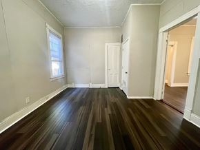 Louisville house for rent - A room with wooden floors and white walls.