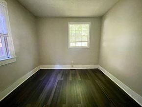Louisville house for rent - A room with a window and wooden floors.