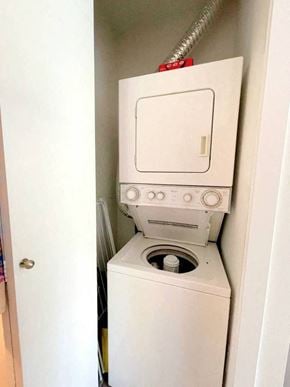 Vancouver apartment for rent - A white washing machine with a red hose attached to it.