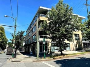 Vancouver apartment for rent - A street view of a building with a tree in front of it.