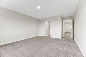 Beaumont apartment for rent - A spacious room with a carpeted floor and white walls.