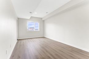 Beaumont apartment for rent - A room with wooden flooring and a window showing a view of a building.