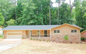 Decatur apartment for rent - A house with a garage and a stone wall.