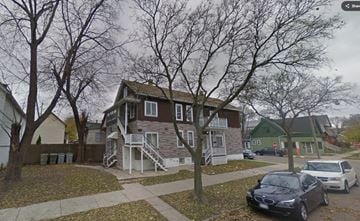 Milwaukee apartment for rent - A house with a car parked in front.