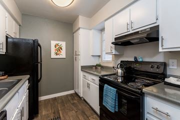 Phoenix apartment for rent - A kitchen with a black refrigerator and stove.